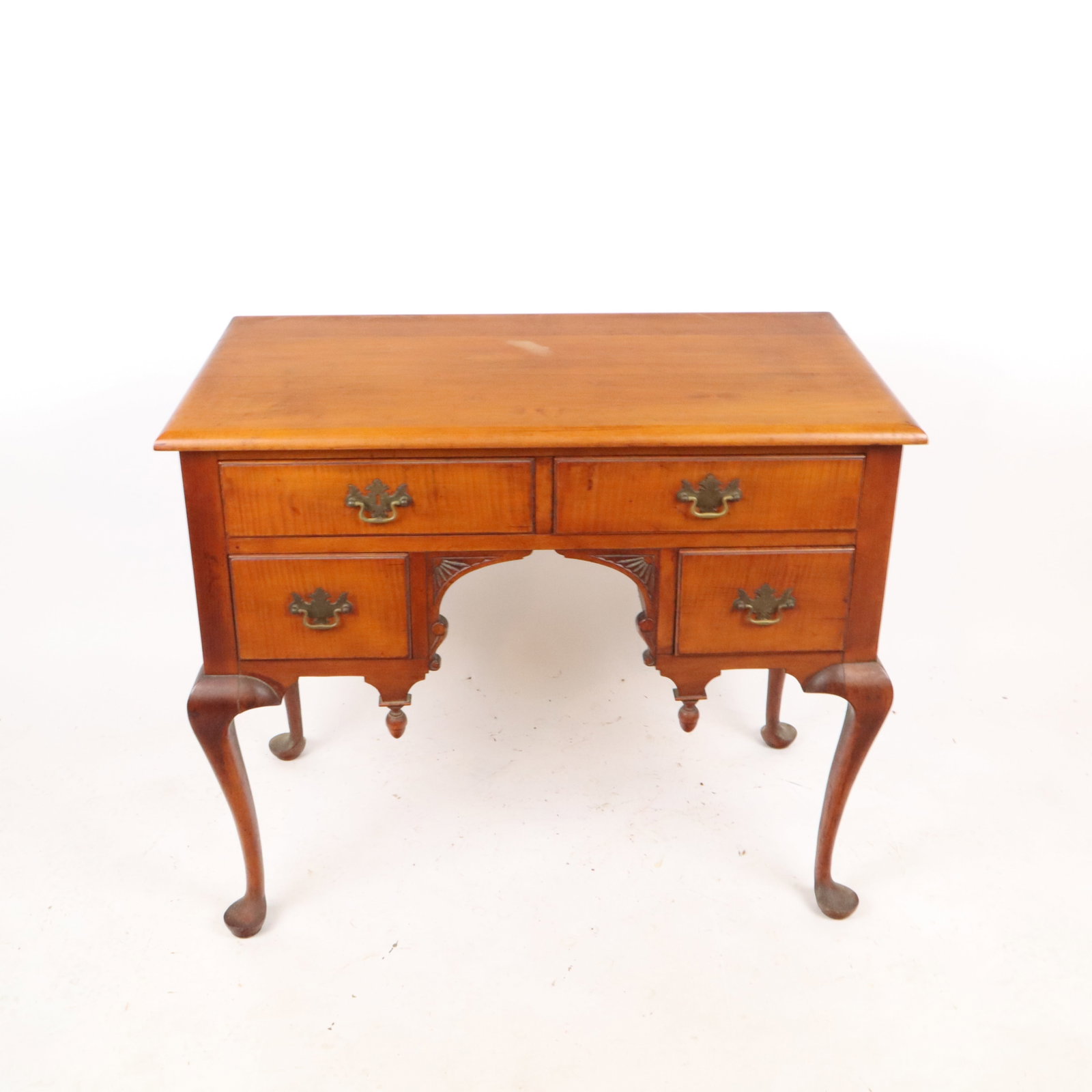 Queen Anne Mahogany Lowboy Desk: Queen Anne mahogany lowboy desk, 20th century, with four drawers, carved details, and four cabriole legs terminating in pad feet. [30" H x 36" W x 21" D]. Condition is good with some minor discolorati