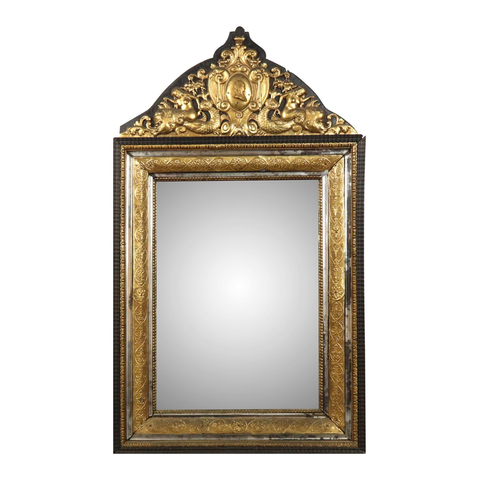 Dutch Repousse Mirror: Dutch repousse mirror, 19th century, with gilt bronze mounts and gilt detail at inner frame, and original beveled glass. [43" H x 24" W]. Condition is good with some patina to bronze and age-commensur