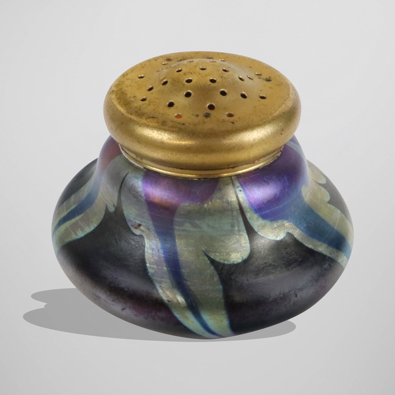 Tiffany Studios Favrile Glass & Bronze Powder Jar: Louis Comfort Tiffany iridescent Favrile glass and gilt bronze lidded powder jar, first quarter of the 20th century, etched on base with Studio monogram. [2" H x 2.25" W]. Overall condition is good.