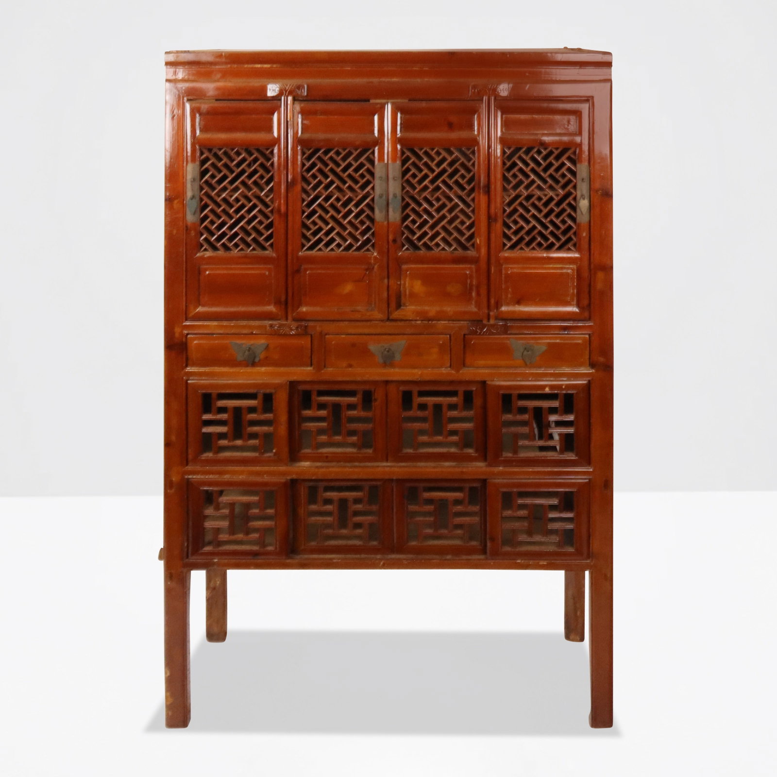 Chinese Reticulated Wood Cabinet: Chinese cabinet, early 20th century, with four reticulated doors to upper compartment over three butterfly mounted drawers, and two compartments to lower with sliding doors. [73" H x 42" W x 20" D]. C