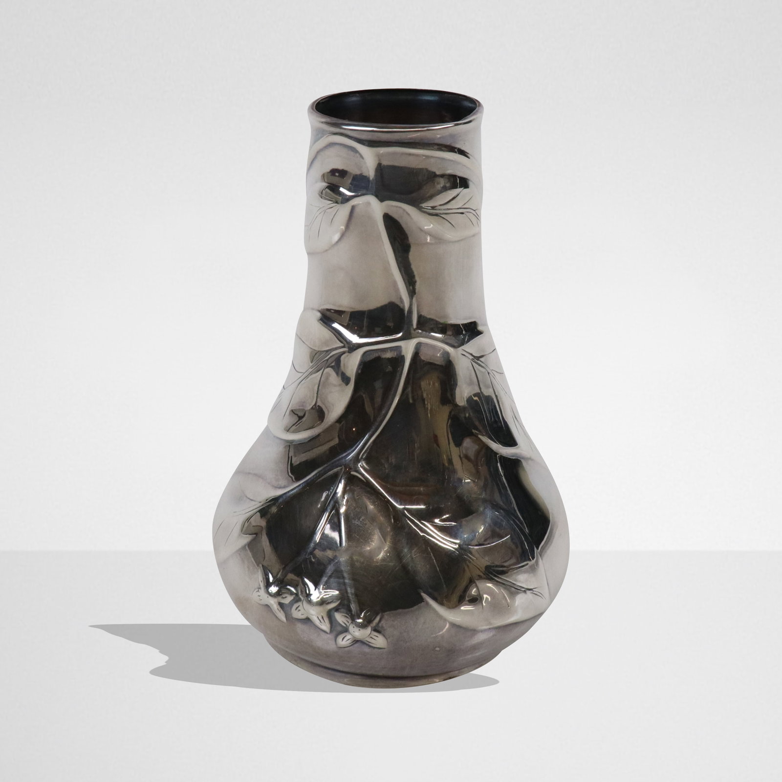 Tiffany & Co. "Louis Comfort Tiffany" Silver Vase: Tiffany & Co. sterling silver "Louis Comfort Tiffany Collection" leaf decoration to one side bud vase, marked on underside of base. [4.5 ozt., 5.5" H x 3.5" Diameter]. Overall condition is good.