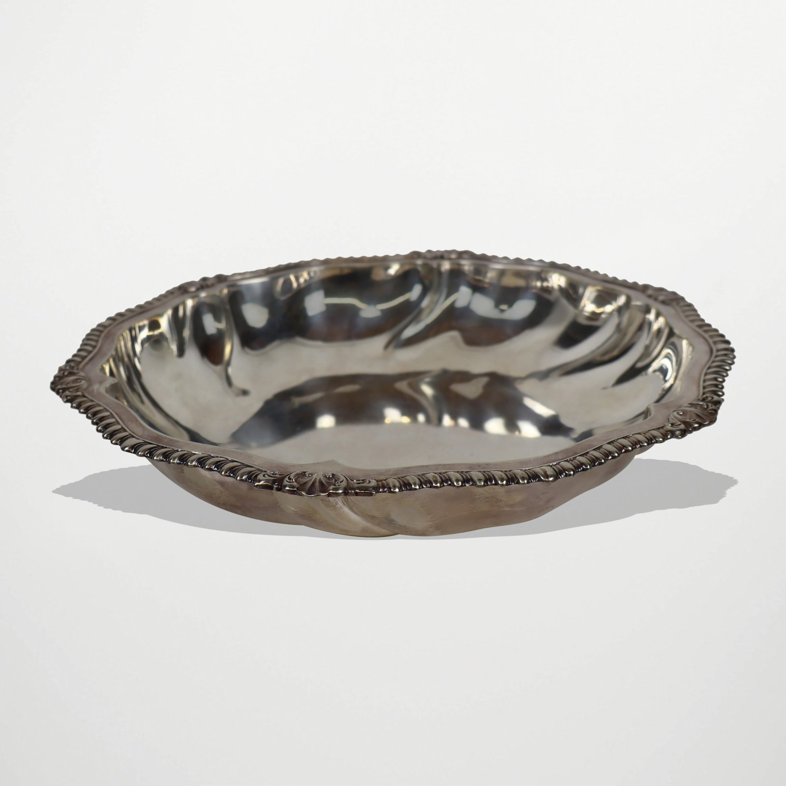 Eugen Marcus German Silver Bowl: German 835 quality silver bowl designed by Eugen Silver, Berlin, first quarter of the 20th century, the shaped bowl with gadrooned border, mark to underside of the lip. [16.5 ozt.; 11.75" Diameter]. O