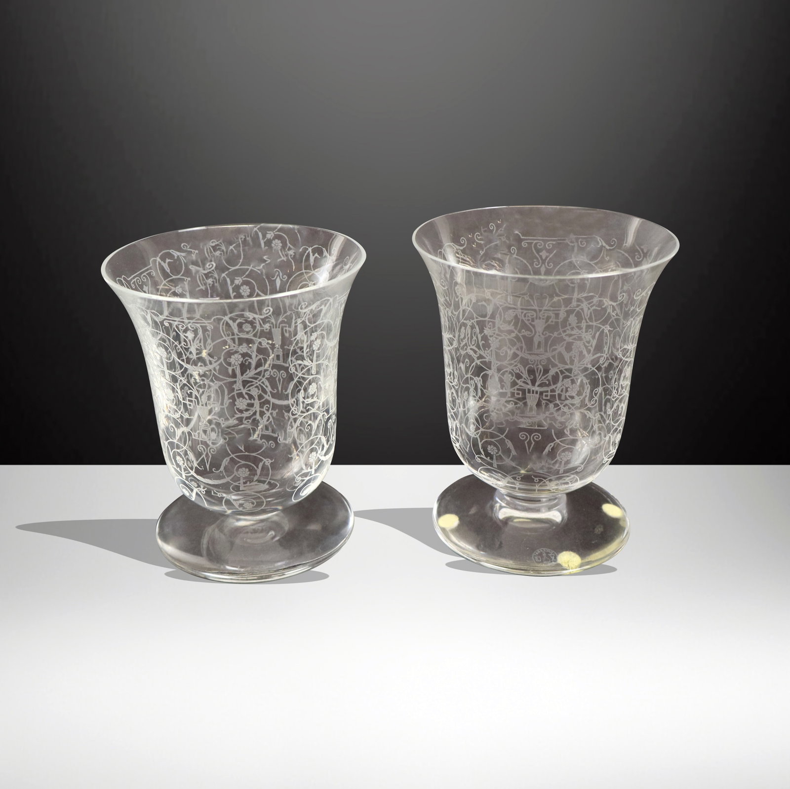 Baccarat Pair of Etched Crystal Urns: Baccarat pair of etched crystal urn form garnitures, etch stamp to base. [5" H x 4.25" Diameter]. Overall condition is good,