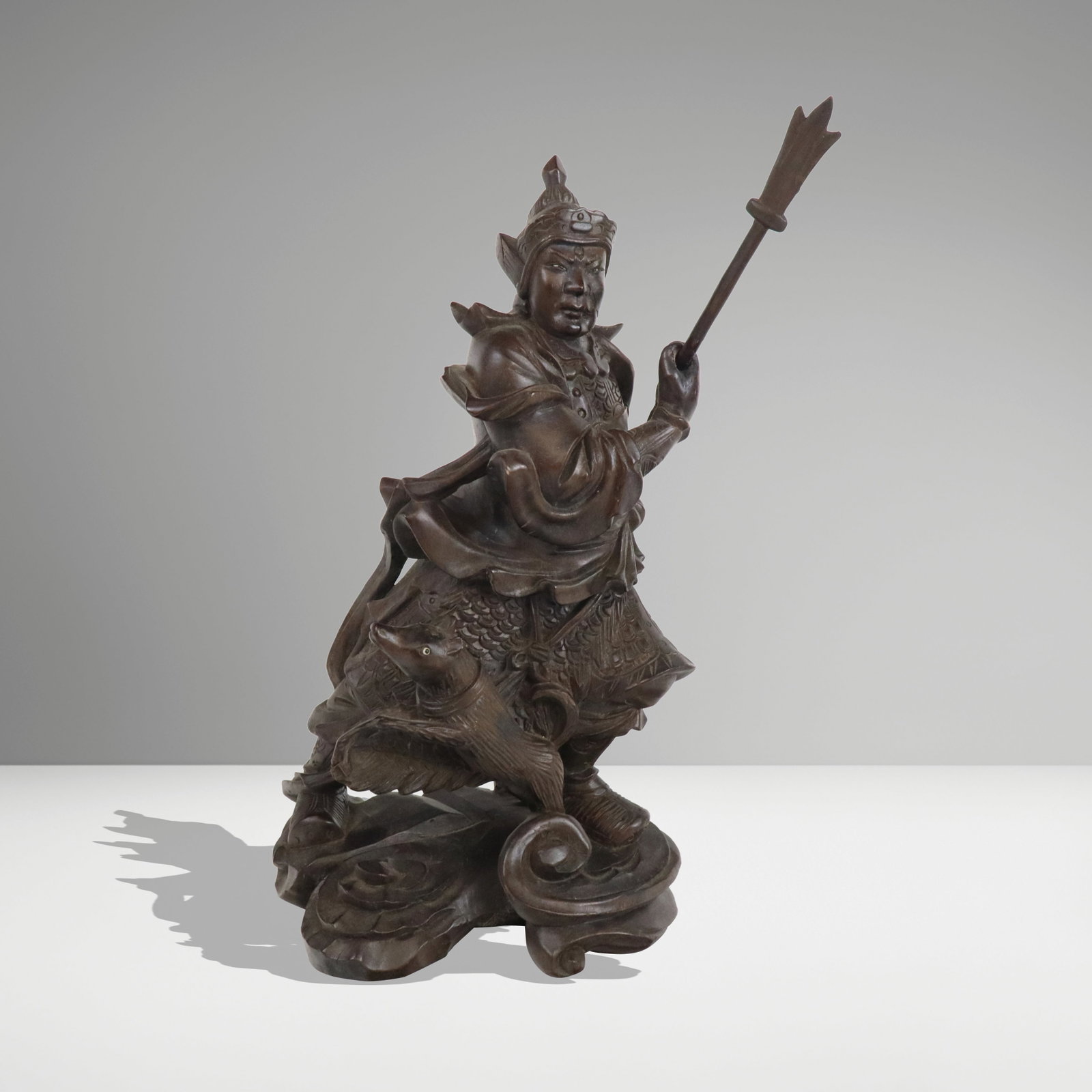 Chinese Carved Wood Sculpture of Yang Jian: Chinese carved wood sculpture of Yan Jian, 20th century, wielding a spear and accompanied by Xiaotian Quan, each with inset eyes, on a cloud form base. [14" H x 8.5" W x 10" D]. Condition is good with