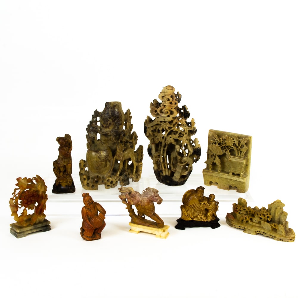 Collection of Carved Soapstone Figures & Ornaments: Collection of assorted carved soapstone figures and ornaments, variously decorated, comprising three figures groups, four depicting animals, a landscape and flowers in a pot. [Largest with monkeys: 9.