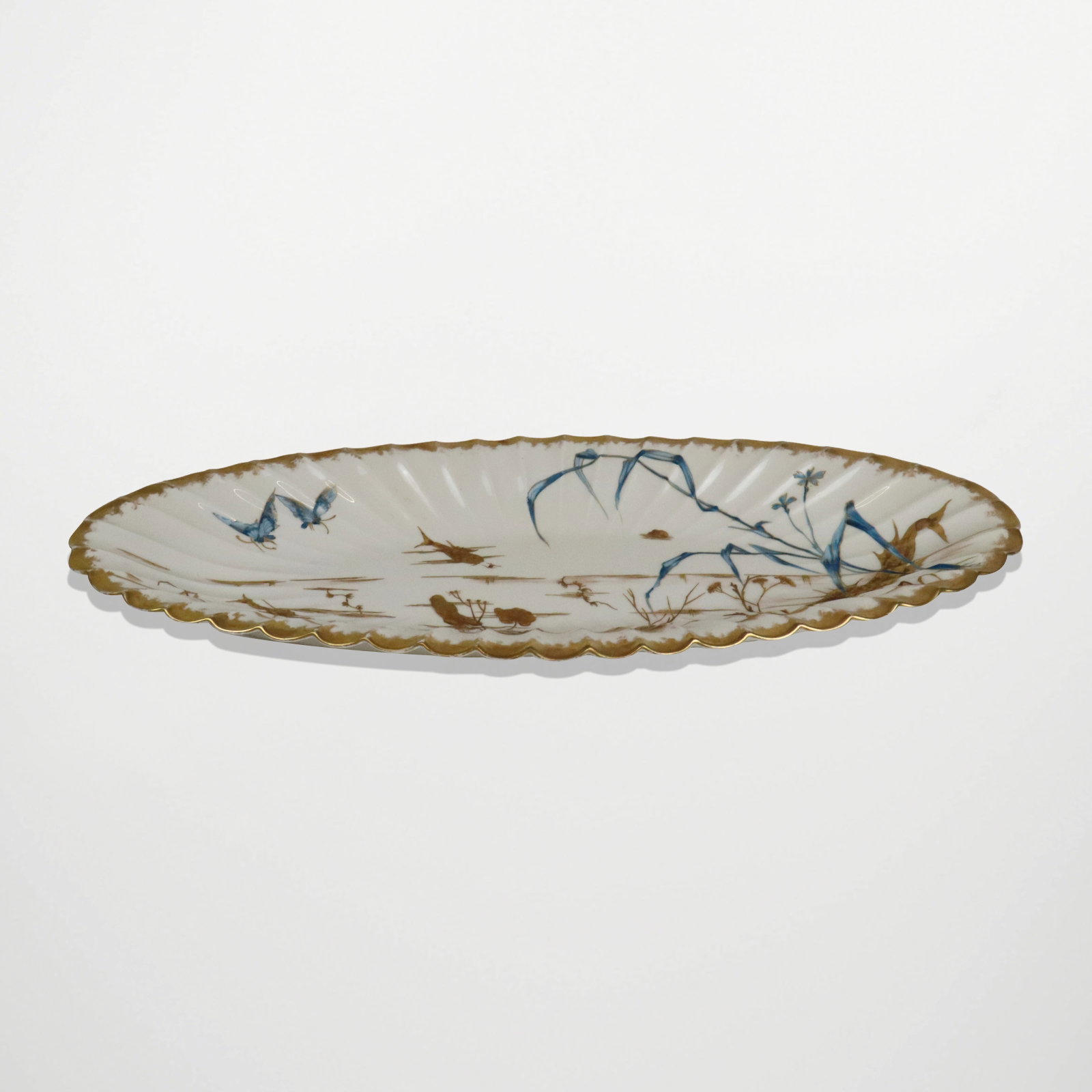 Veuve Etienne Gilt Decorated Fish Platter: Veuve Etienne gilt decorated fish platter, Paris, probably late 19th century, of oblong shape with scalloped border, depicting pond landscape with fish, reeds, and butterflies, mark to reverse. [2" H 