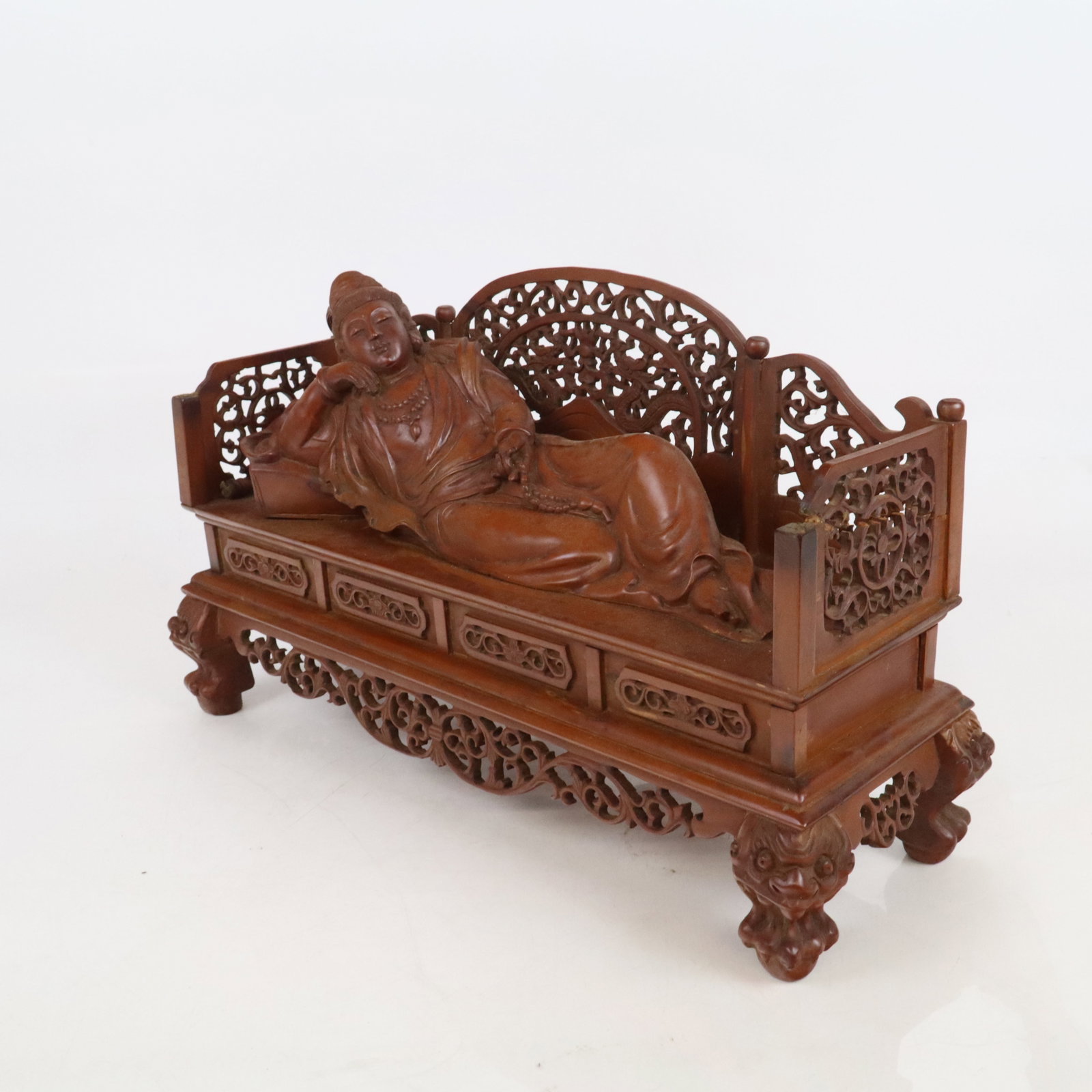 Chinese Carved Wood Sculpture Buddha in Repose: Chinese carved wood sculpture of a Buddha in repose, 20th century, with carved and openwork details. [8.5" H x 15" W x 6" D]. Condition is good with separation to some openwork elements and minor loss