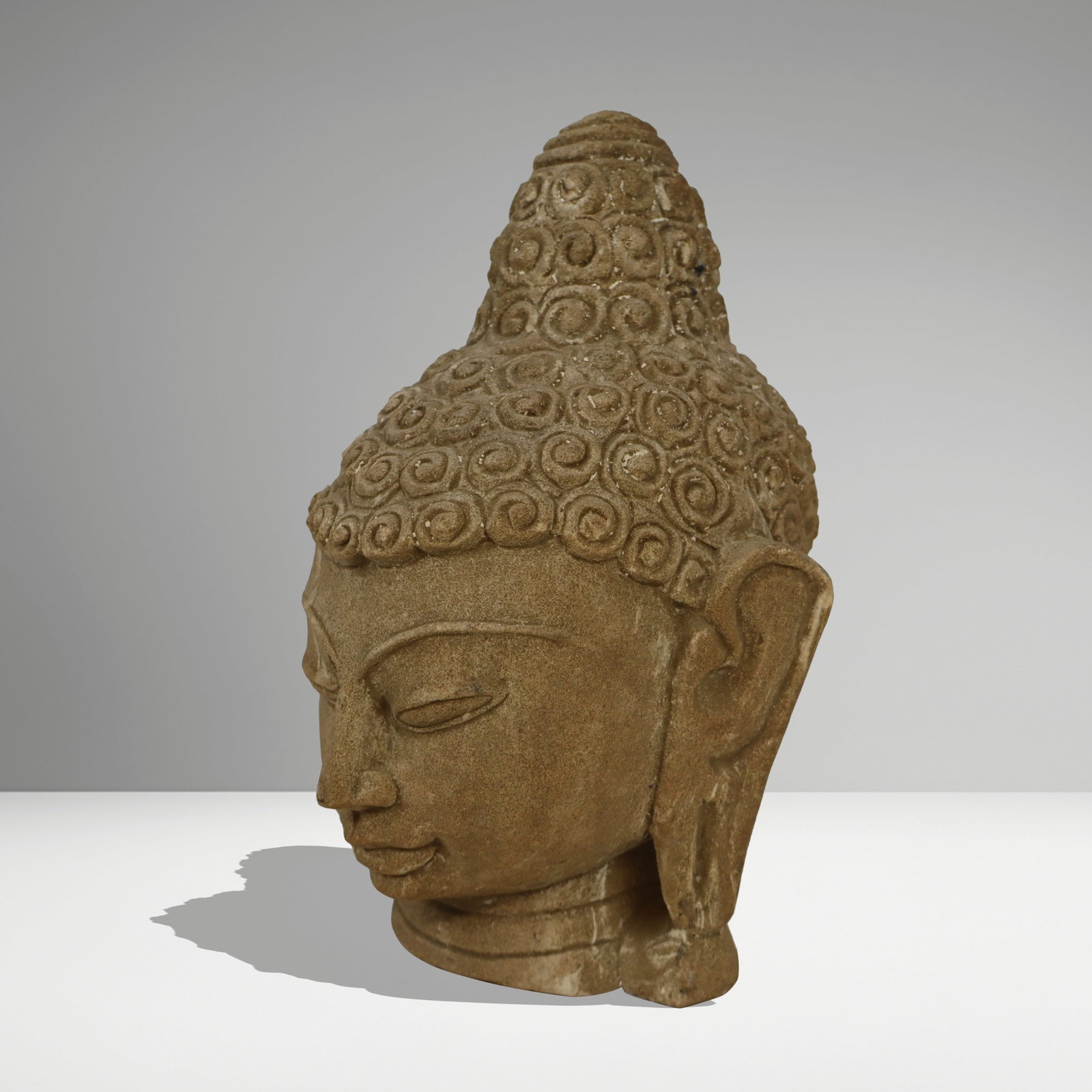 Carved Sandstone Sculpture of Buddha: Carved sandstone sculpture of Buddha, late 20th century. [9.5" H x 7" W x 7" D]. Condition is good with some surface wear.