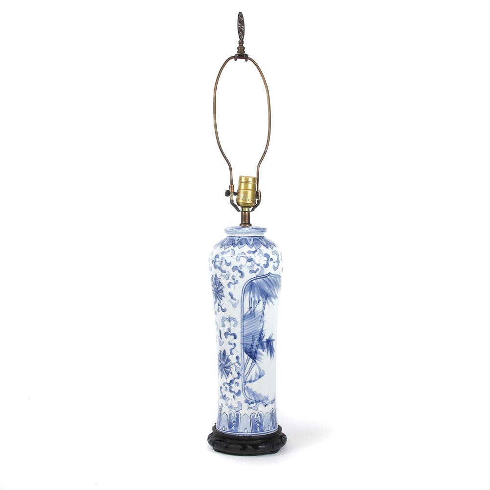 Chinese Blue and White Porcelain Lamp: Chinese blue and white porcelain lamp, later 20th century, with a reticulated wood base and decorative finial. [To socket: 16.5" H x 5.5" Diameter]. Condition is good, wiring untested.