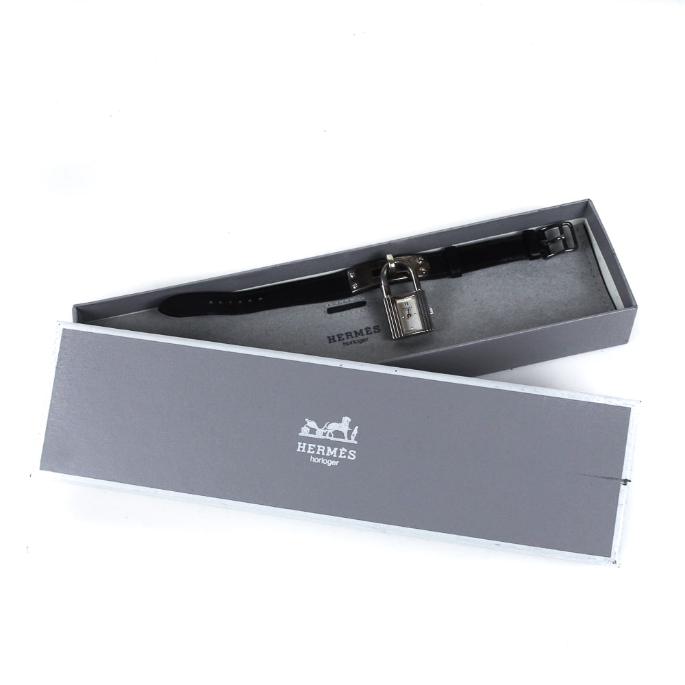 Hermes Sterling Silver & Leather "Kelly" Watch: Hermes sterling silver and black leather "Kelly" watch, signed on the clasp, dial, watch case and leather band, pouch and box. [Leather strap: 8" L x .5" W overall; Watch: 1.5" H x .75" W overall]. Ov