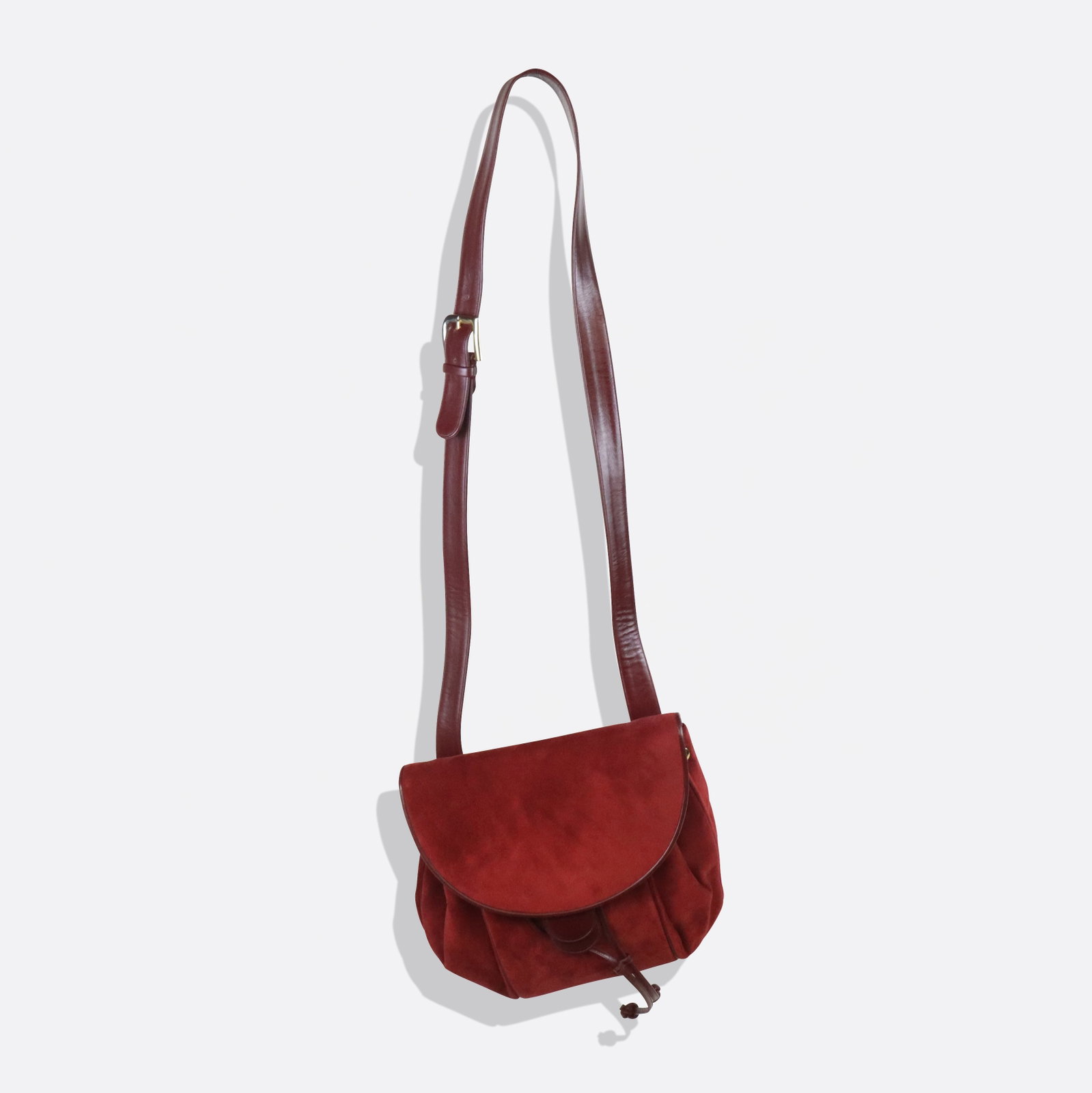 Judith Leiber Red Suede Handbag: Judith Leiber red suede handbag, 21st century, with red leather trim, strap, and gold tone hardware, lined at interior, marked Judith Leiber to interior label, and with original coin purse and pocket 