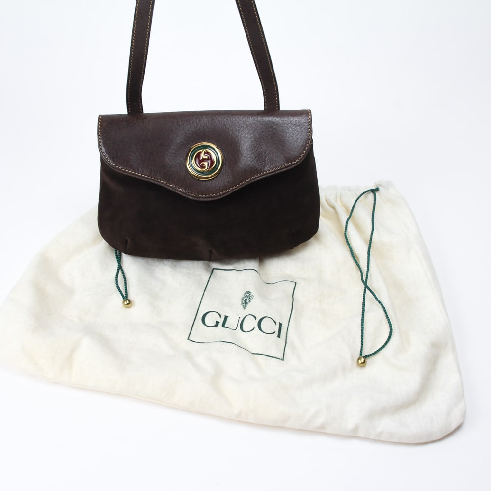 Gucci Vintage Suede Handbag: Gucci vintage suede handbag, 20th century, with an enamel double G decorated clasp, and suede body with leather flap and strap, marked Gucci Boutique, made in Italy to interior, accompanied by a