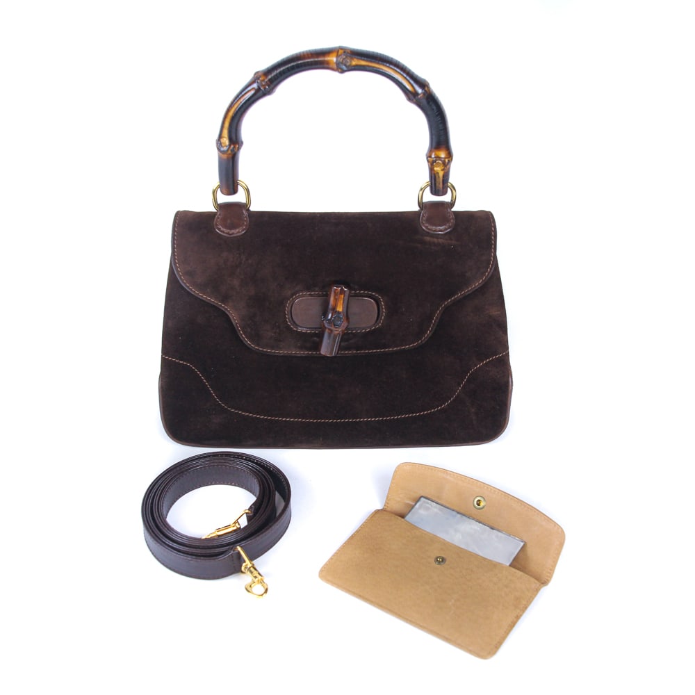 Gucci Suede Handbag with Bamboo Detail: Gucci suede flap handbag, 20th century, with bamboo handle and closure, with a case and pocket mirror to interior, marked Gucci Italy to interior and to interior zipper, and with a strap to interior, 