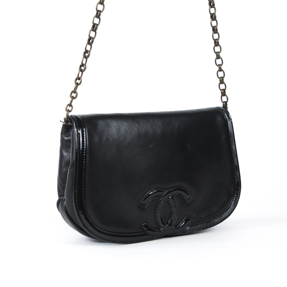 Chanel Lambskin Handbag with Patent Leather Trim: Chanel flap handbag, 21st century, with patent leather trim and double C decoration to flap, marked Chanel to interior, accompanied by a dustbag. [Less chain: 6" H x 9" W x 2" D]. Condition is good to