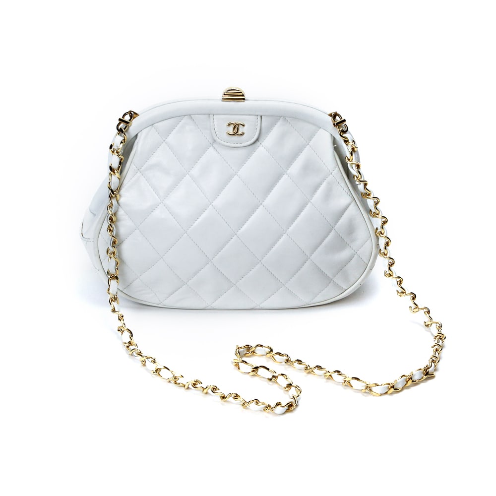 Chanel White Quilted Leather Kiss Lock Clutch Bag: Chanel white quilted lambskin bag, 21st century, with gold-tone hardware, a kiss lock and woven leather and metal strap, with double C at closure and marked Chanel to interior, accompanied by dustbag.