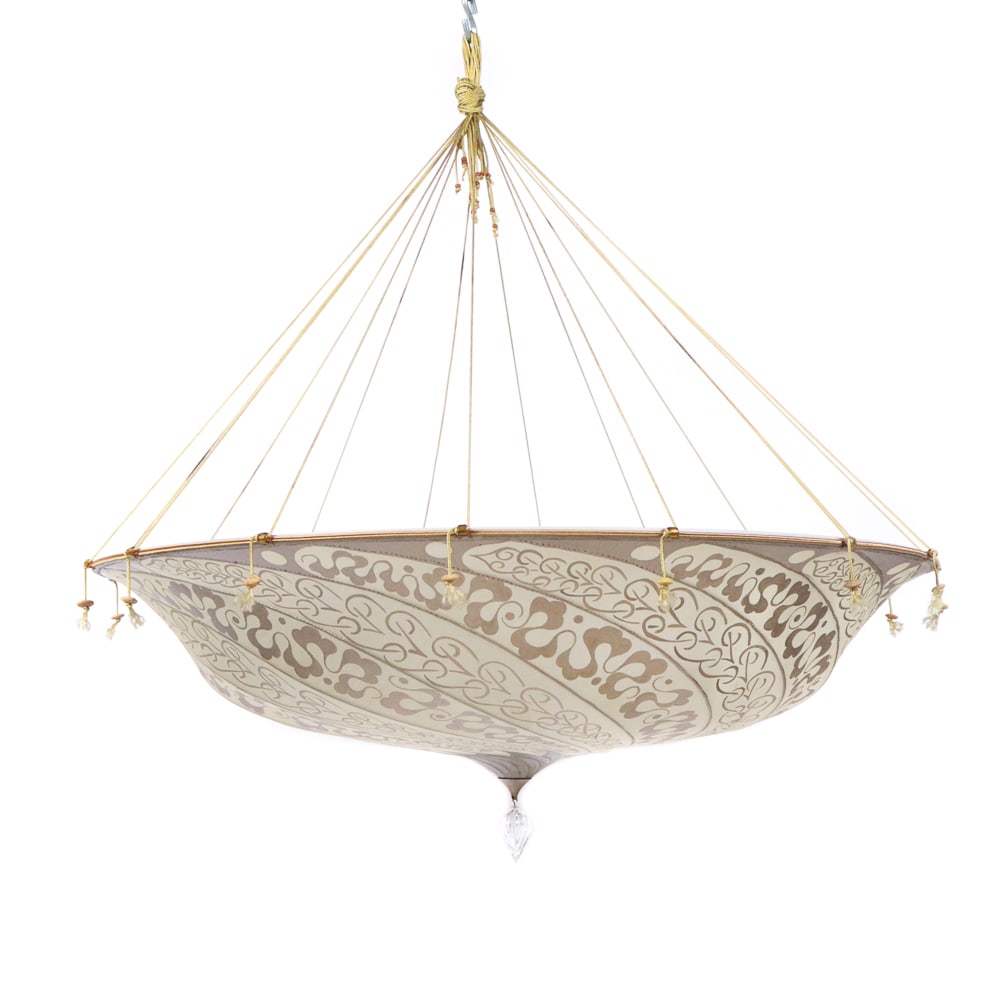 Fortuny "Scudo Saraceno" Silk Chandelier Shade: "Scudo Saraceno" silk chandelier shade by Mariano Fortuny, Italy, 20th/21st century, in gilt printed silk, with an interior acrylic shade, and blown glass pendant, unmarked. [Shade, less hanging imple