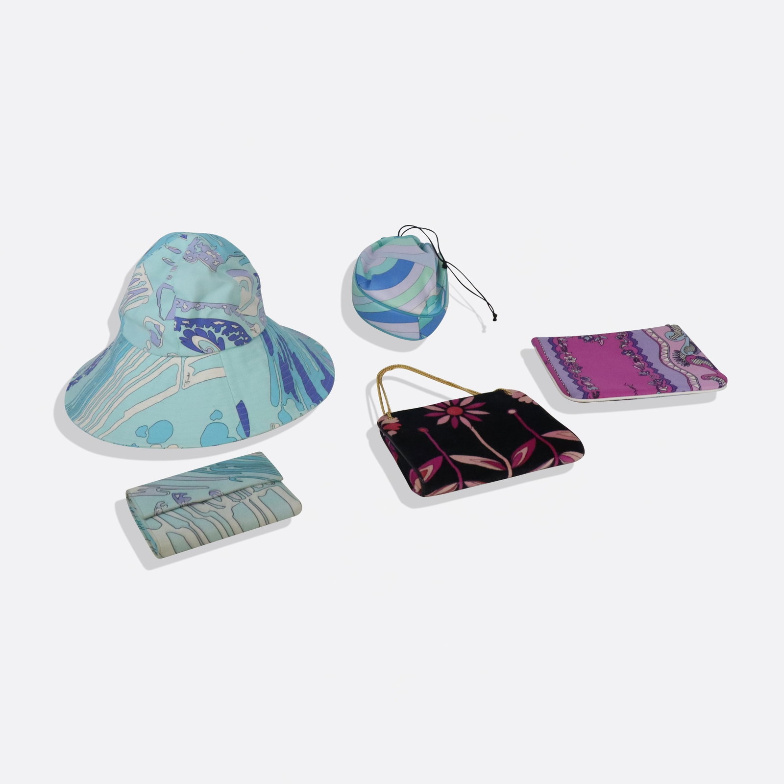 Four Pucci Bags and Accessories: Four small Pucci articles comprising a Pucci printed cotton pouch, a printed velvet handbag, a synthetic drawstring pouch, and a printed leather wallet, all marked Pucci, most with further markings to