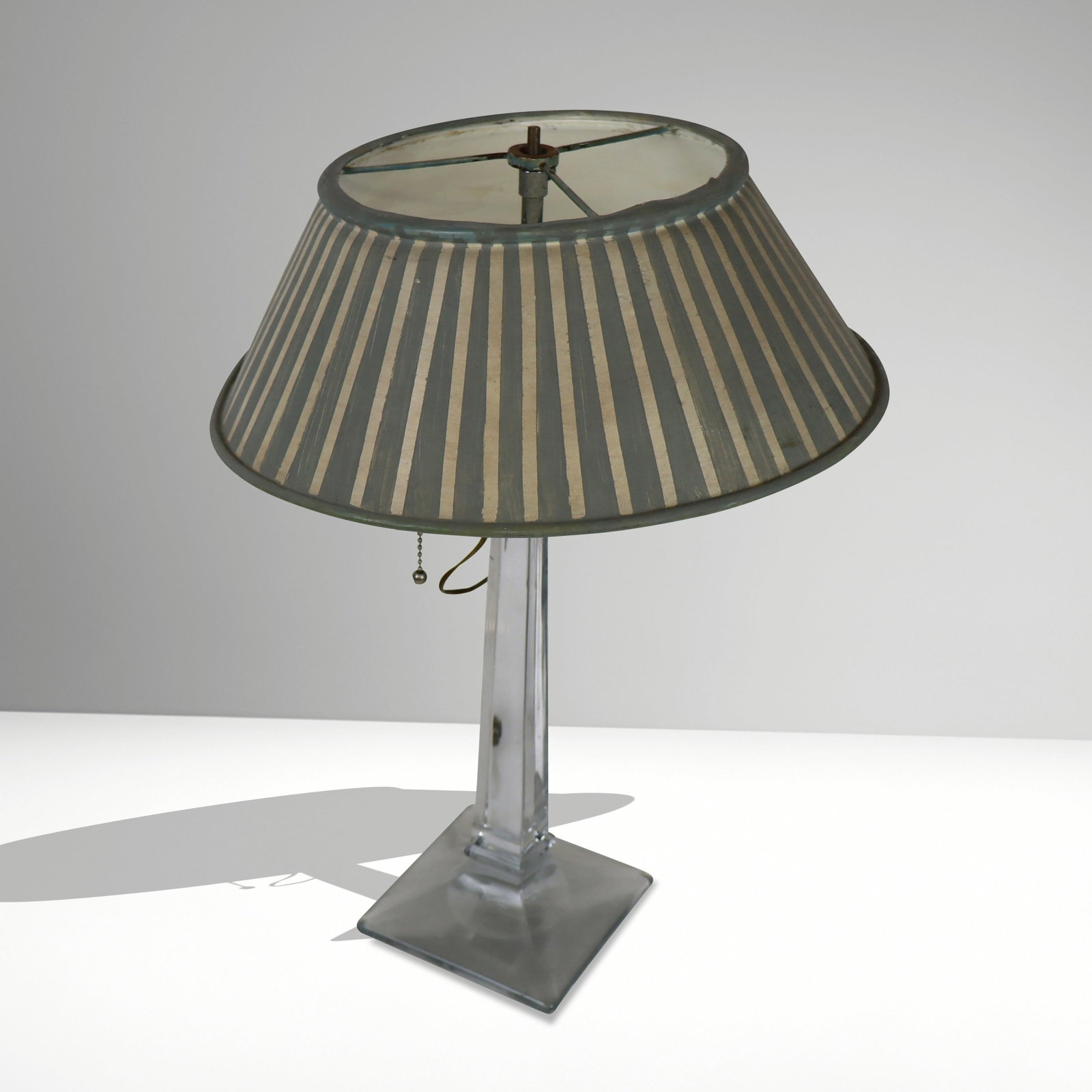 Modern Glass Lamp with a Later Tole-Painted Shade: Modern glass lamp with a later tole-painted shade with hand-painted stripe detail. [Including shade: 18" H x 12.25" Diameter]. Condition to base is good with surface wear, shade with age-commensurate 