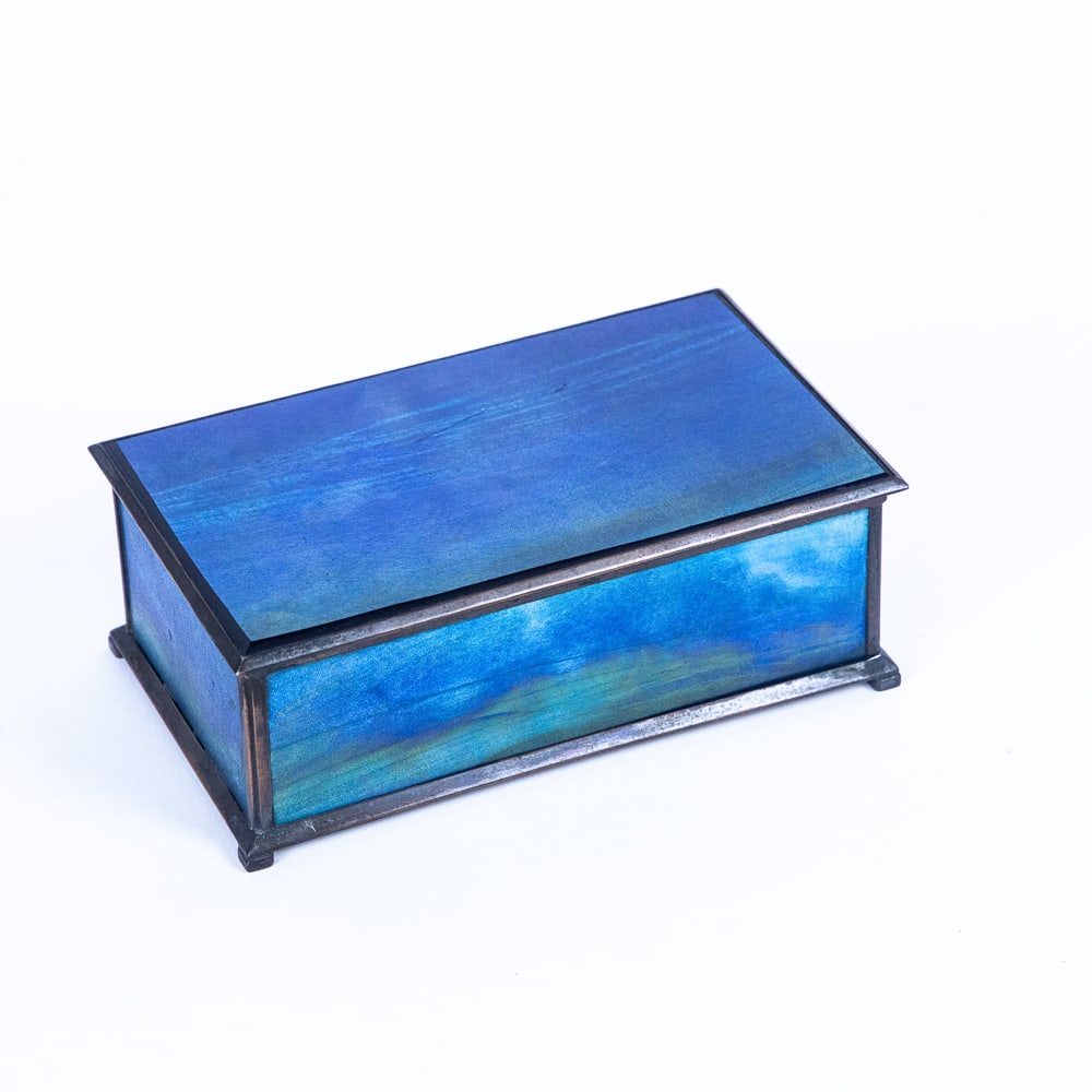 Tiffany Furnaces Favrile Glass & Bronze Box: Tiffany Furnaces purple to blue Favrile glass and bronze hinged box, 1902-1920, predominantly in blue with purple yellow and green accents, mark to underside base frame Tiffany Furnaces Inc. 113 with 