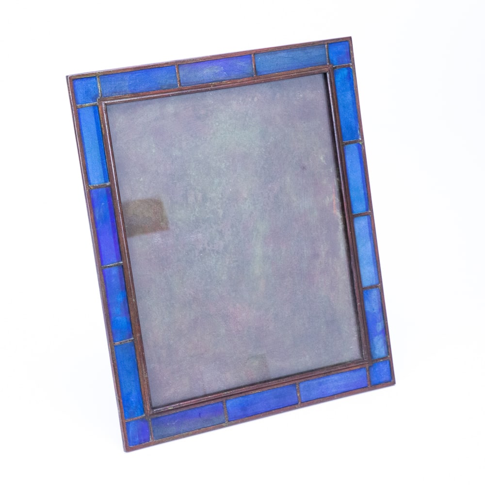 Tiffany Studios Favrile Glass & Bronze Frame: Tiffany Studios Favrile glass and bronze easel back picture frame, first quarter of the 20th century, the bronze cells retaining iridescent blue and purple Favrile glass panels, mark to back Tiffany S