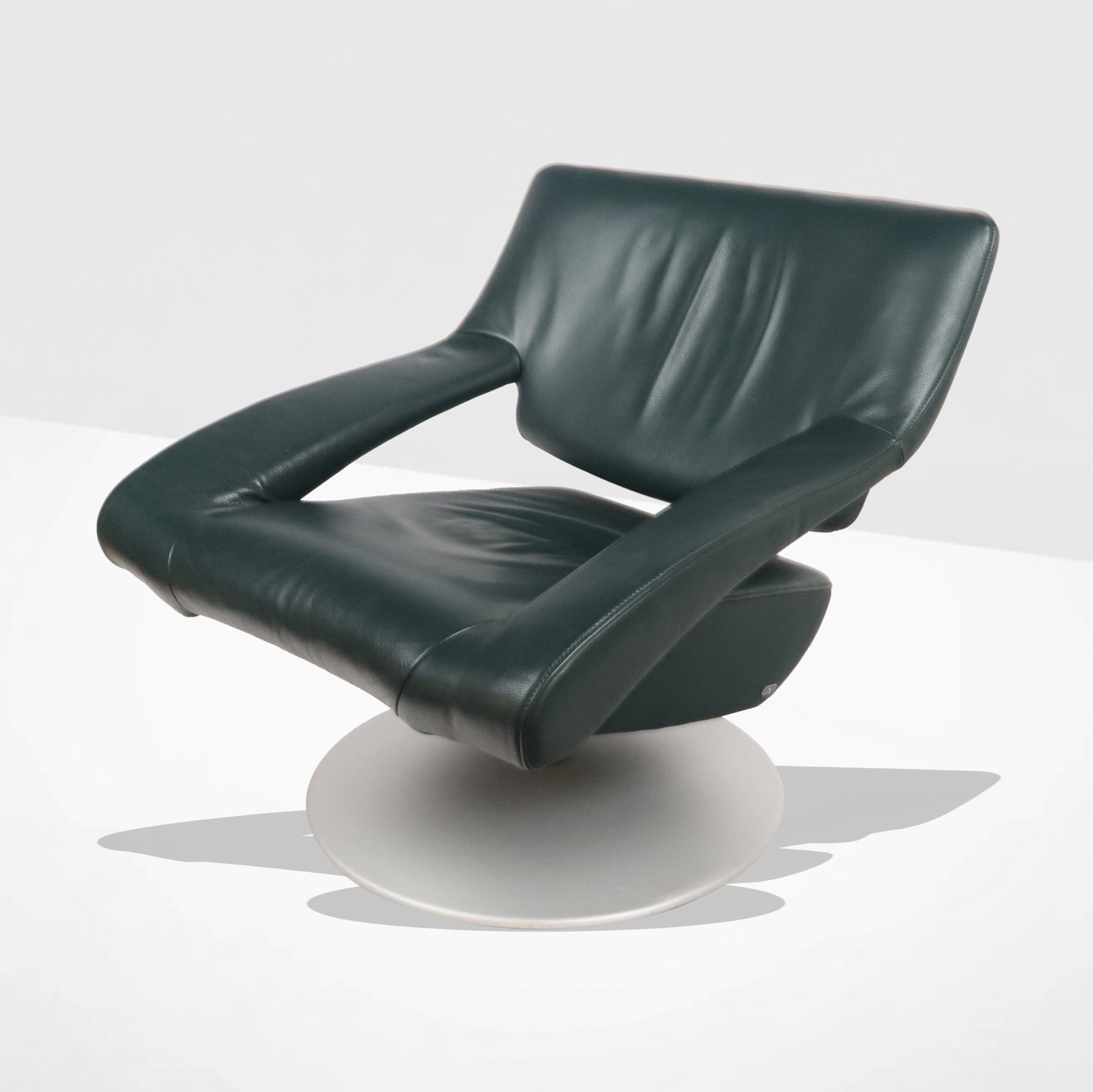 de Sede Green Leather Swivel Armchair: de Sede green leather swivel "DS-0255" model armchair with weighted brushed metal base, Swiss, probably last half of the 20th century, bearing "S" shaped logo. [32" H x 31" W x 31" D]. Overall conditi