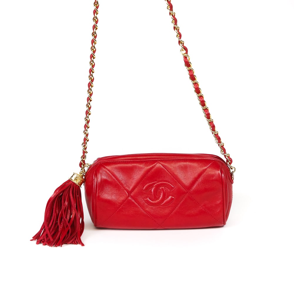 Chanel Quilted Lambskin Crossbody Barrel Bag: Chanel quilted lambskin crossbody Barrel bag, 21st century, with gold tone hardware and a red leather tassel, with double C monogram to outer and at hardware, marked Chanel and Made in Italy to interi