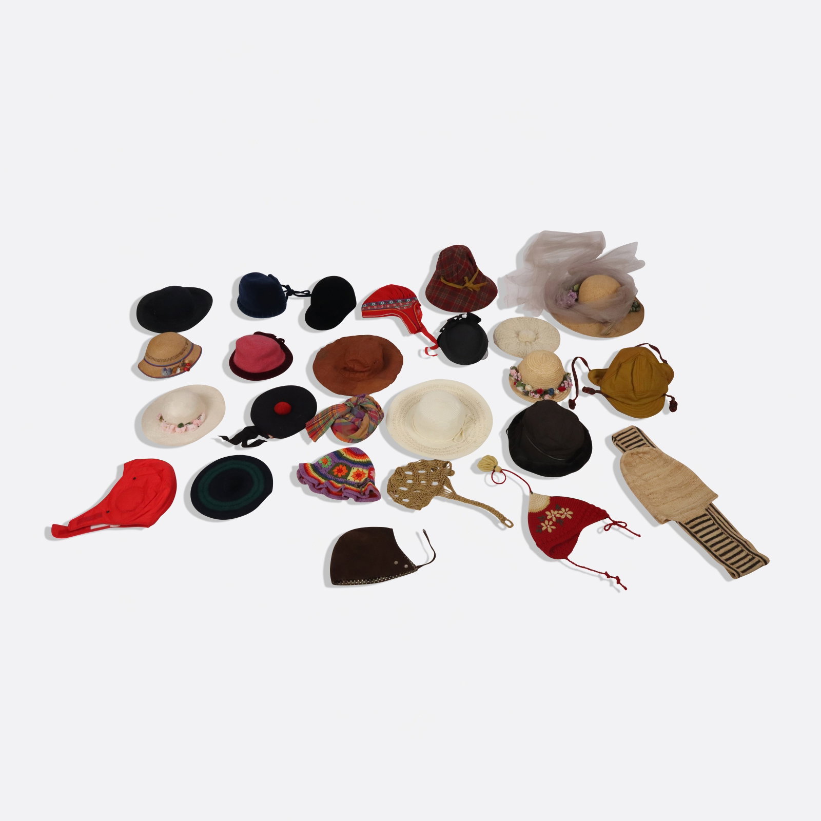 Collection of 25 Women's Hats: Collection of vintage women's hats including a black velvet riding cap by Kauffman, an Importina black straw head with bow detail, a Christa crocheted gold cap, a blue velvet hat by The White House wi