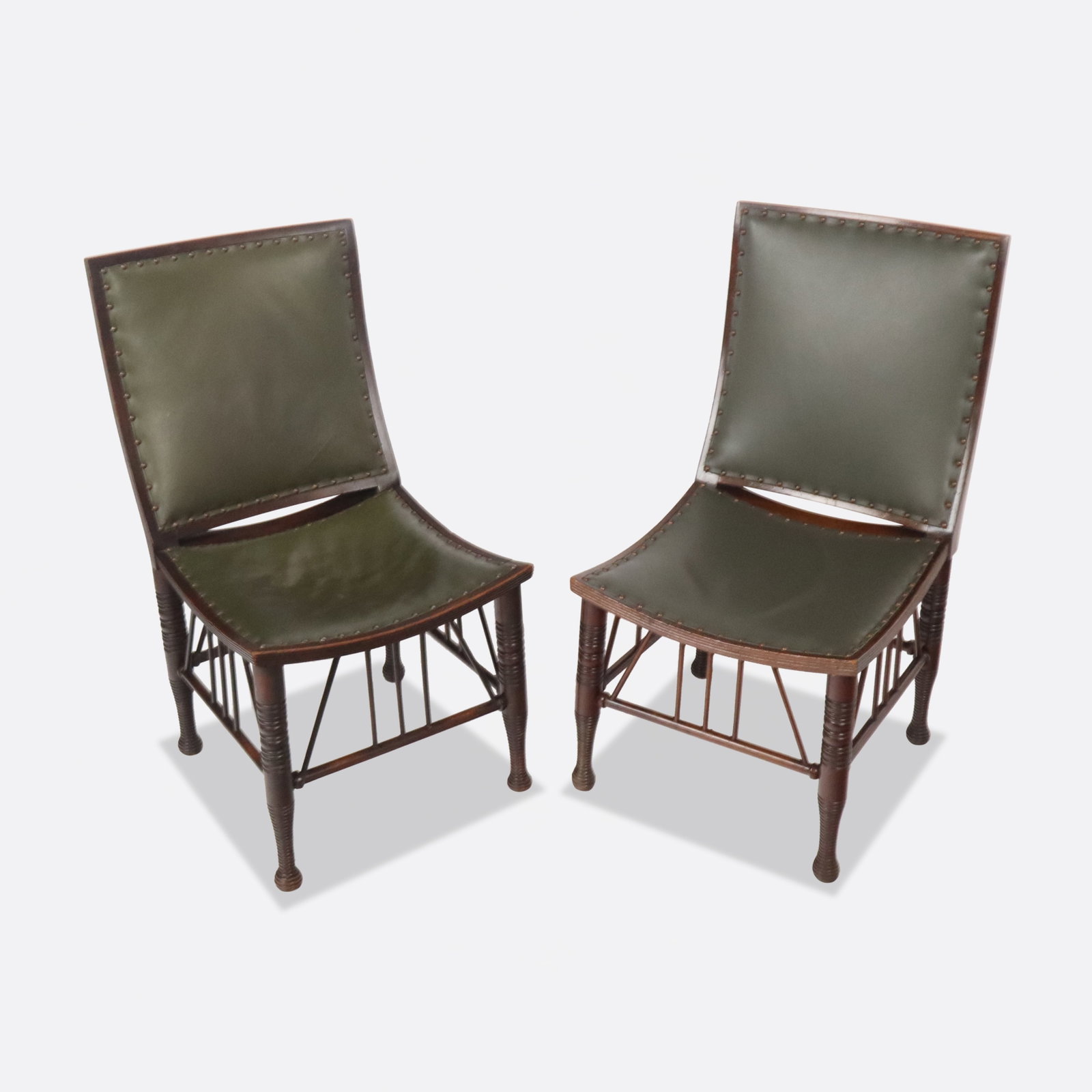 Liberty & Co Attr Pair Arts & Crafts Thebes Chairs: Pair of Arts and Crafts mahogany and leather upholstered "thebes" side chairs, circa 1900, attributed to Liberty & Co. with brass tack detail. [35.5" H x 19" W x 20" D; seat height: 17"]. Condition is