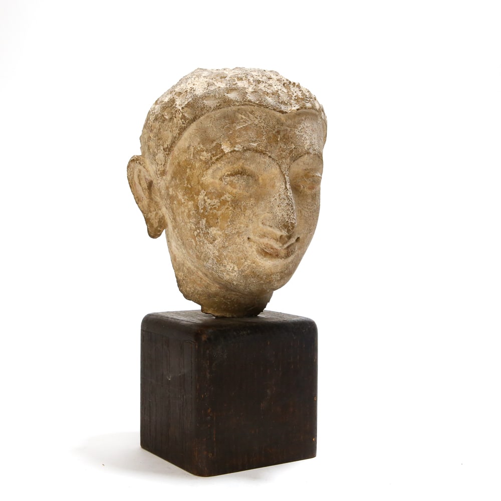Gandharan Stucco Head of Buddha: Gandharan stucco head of Buddha, India/Pakistan (Gandhara), circa 2nd or 3rd century, with an aquiline nose and deep hairline, on a stand. [Less stand: 6" H x 5.5" W x 5.75" D]. Condition with age com