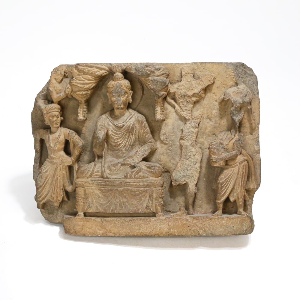Ghandharan Grey Schist Panel of Buddha Shakyamuni: Ghandharan carved grey schist panel of Buddha Shakyamuni, India/Pakistan (Gandhara), circa 2nd or 3rd Century, accompanied by attendants, with carving to upper. [10" H x 7.5" W x 3" D]. Condition with