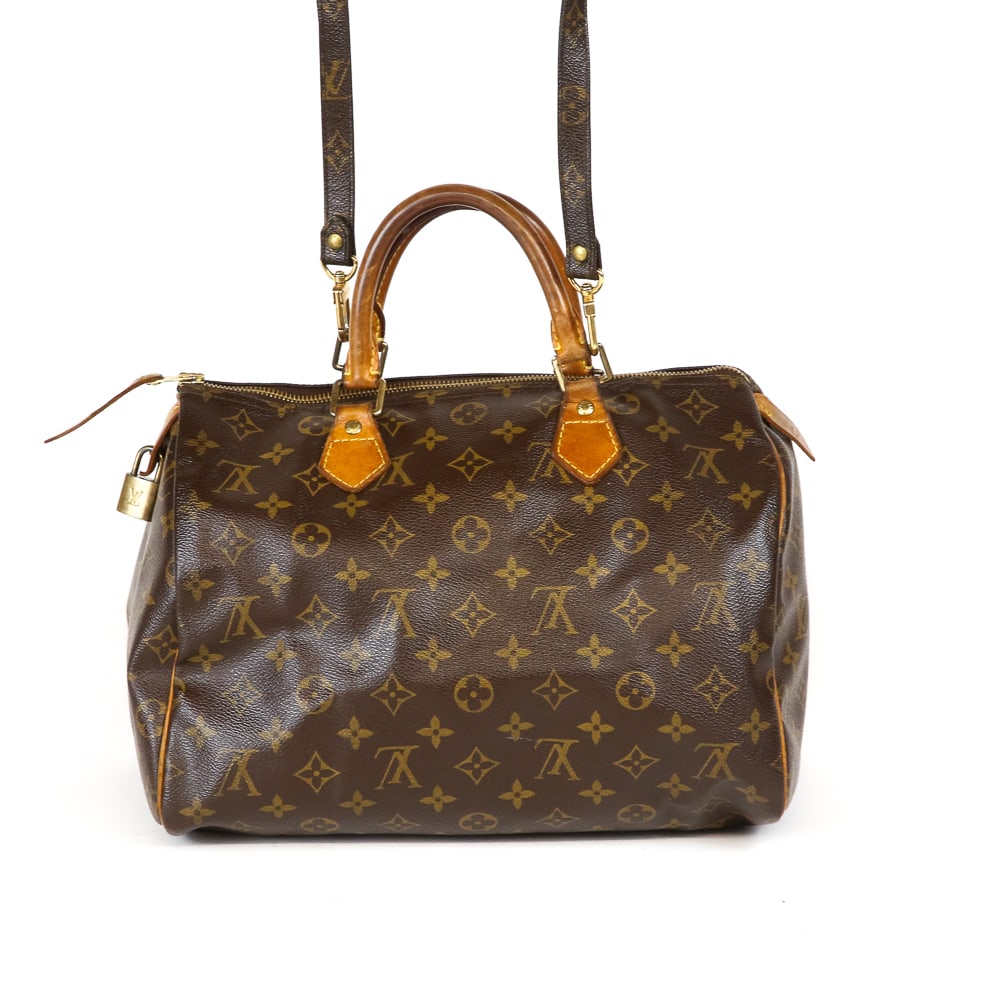 Louis Vuitton Speedy 30 Handbag: Louis Vuitton Speedy 30 handbag, early 21st century, with LV monogram print to exterior and to strap, hardware and lock marked Louis Vuitton, and with a canvas lined interior, interior marked with num