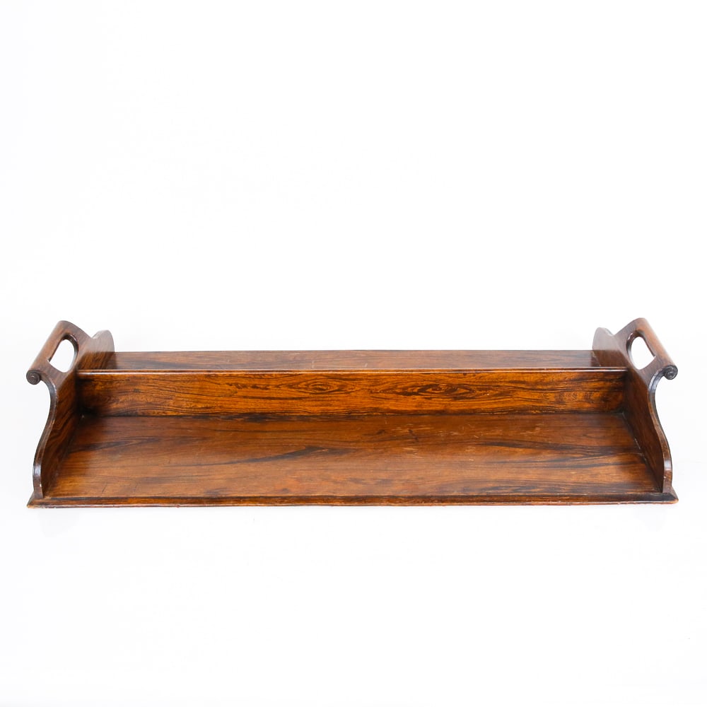 Rosewood Serving Tray: Rosewood two-handled serving tray, 19th century, with carved and scrolled handles and divider to center. [4.5" H x 27.25" W x 14" D]. Condition is good with light age-commensurate wear.