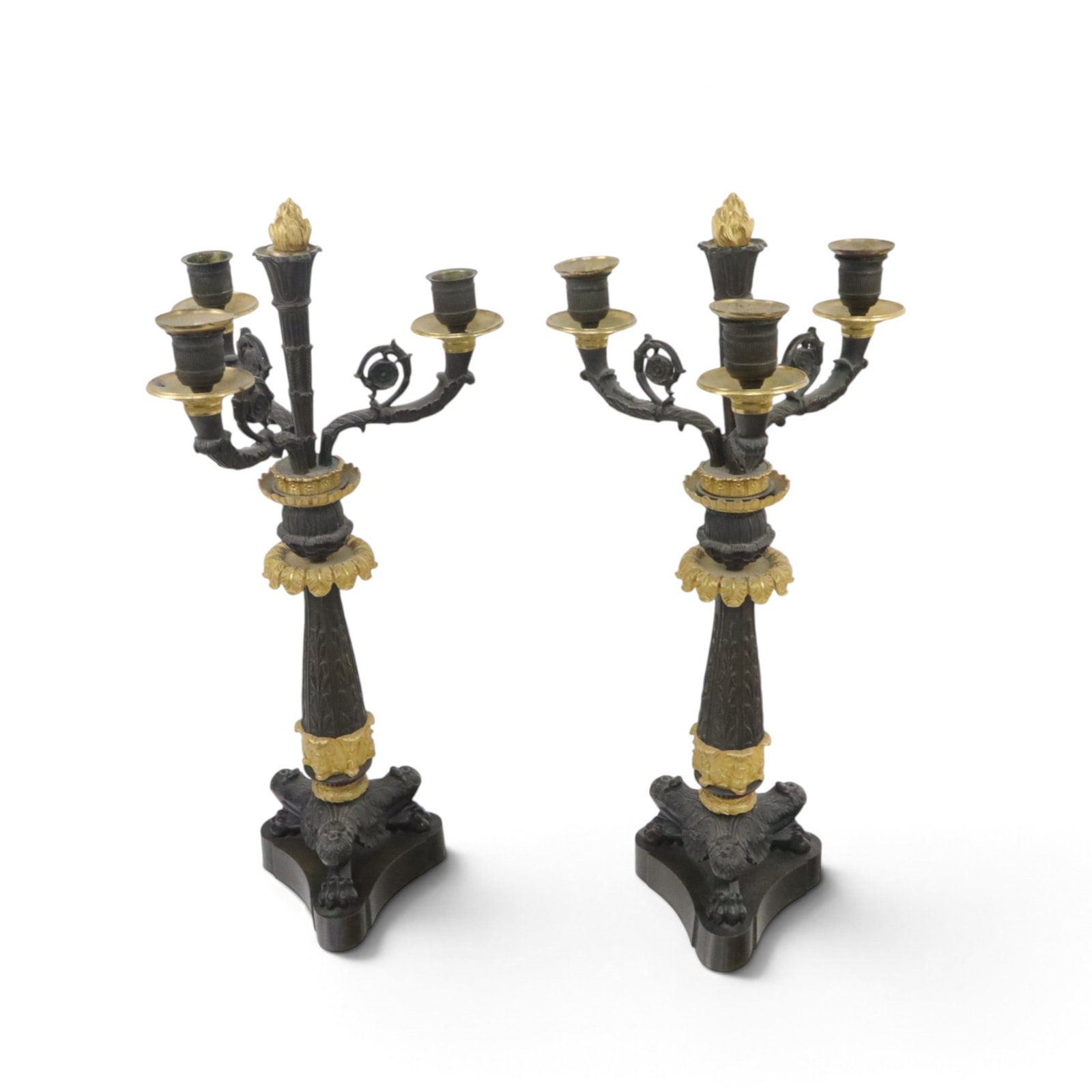 Pair of Empire Bronze Two-Tone Candelabra: Pair of Empire ornately decorated three-light candelabra, 19th century, on paw foot bases, with flame finials. [20" H x 9" Diameter]. In overall good condition.