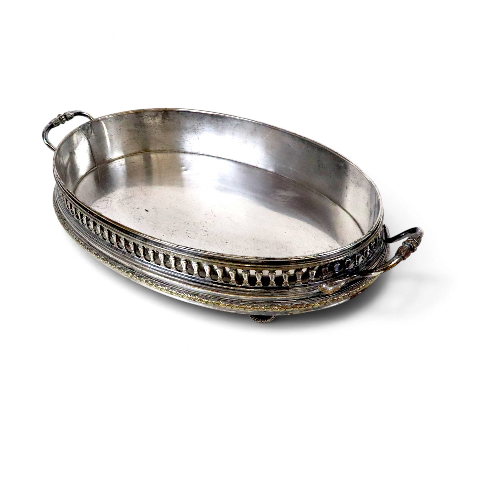 Silver Plate Double Handled Centerpiece: Silver plate double handled center, the border designed as a balustrade, with oval metal liner. [3.25" H x 18.75" L x 10.25" W]. Overall condition is fair, metal visible, liner repaired in several pla