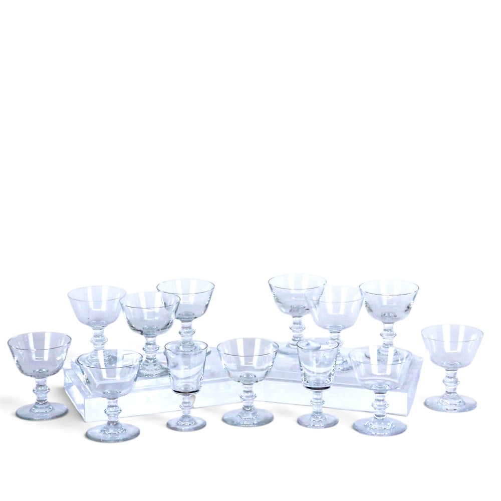 Baccarat "Embassy" Crystal Glasses, 13: Baccarat set of eleven "Embassy" pattern champagne saucers, mark on underside of foot. [4.5" H x 4.75" Diameter], and two cordials [4.5" H x 2.75" Diameter], mark to underside of foot. Overall conditi