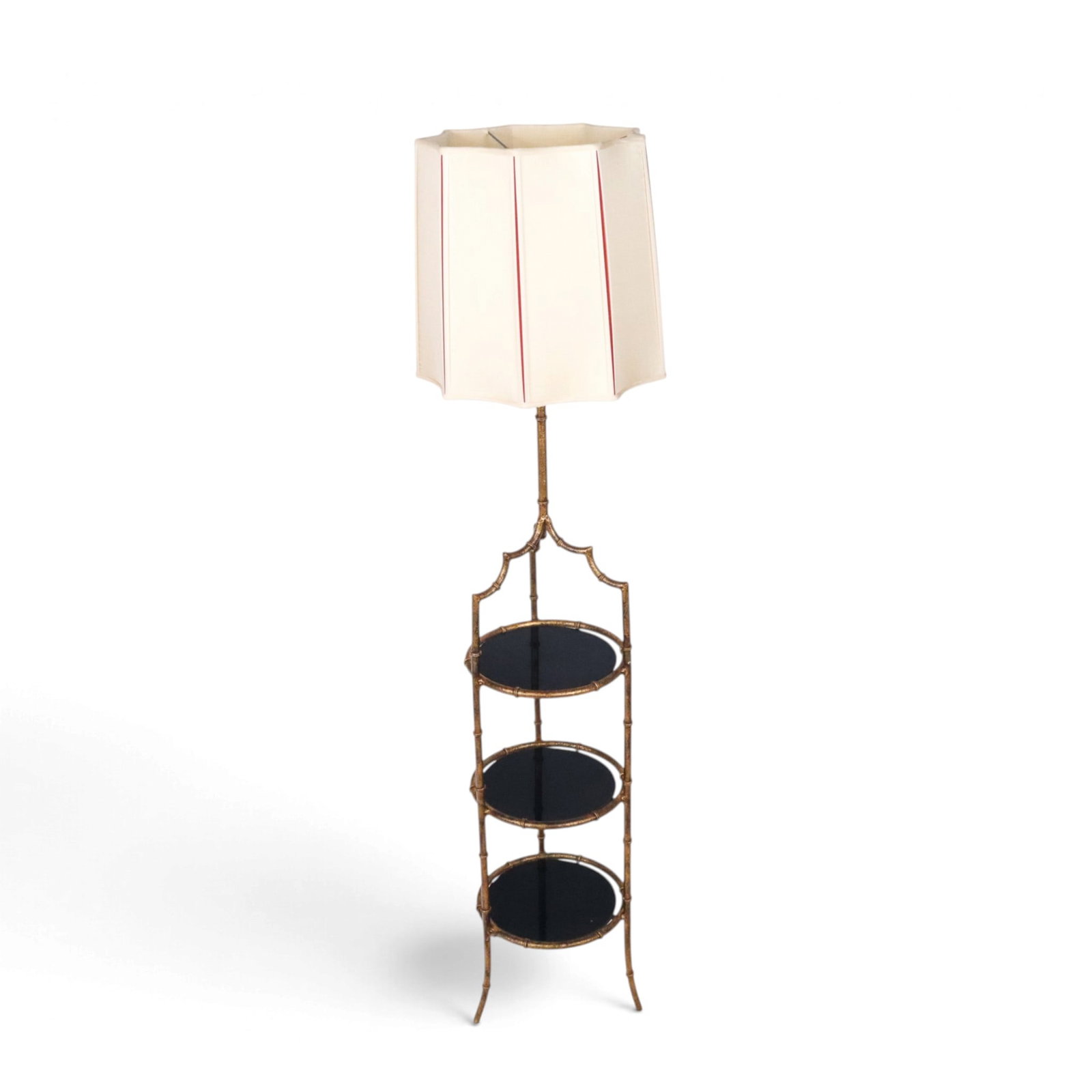 Hollywood Regency Faux Bamboo Stand Lamp: Hollywood Regency faux bamboo stand, 20th century, with three black glass inset tiers, and with three sockets to upper, abd scalloped shade. [Including shade: 62" H x 13.5" Diameter]. Condition is goo