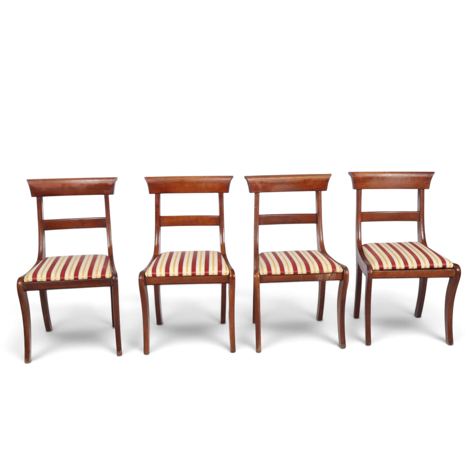 Four Mahogany Klismos Chairs: Four mahogany Klismos chairs, 19th century, with striped upholstery to seats. [33" H x 19" W x 20" D; seat height: 17"]. Condition is good with fading and discoloration to seats, including staining.