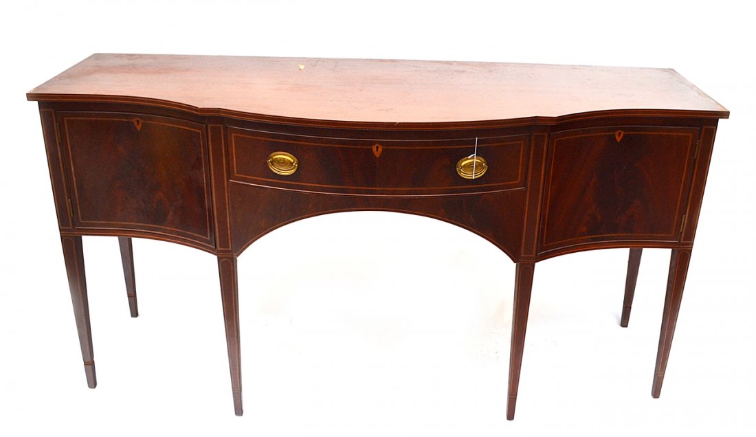 Biggs Mahogany Sideboard: Serpentine mahogany sideboard with two doors above one drawer by "Biggs". In the Hepplewhite style. Needs polish.