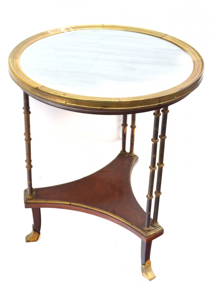 Jansen Manner Gueridon: A French burl walnut marble inset and bronze gueridon, double chinoiserie style supports. [24" Dia x 28 1/4" H]