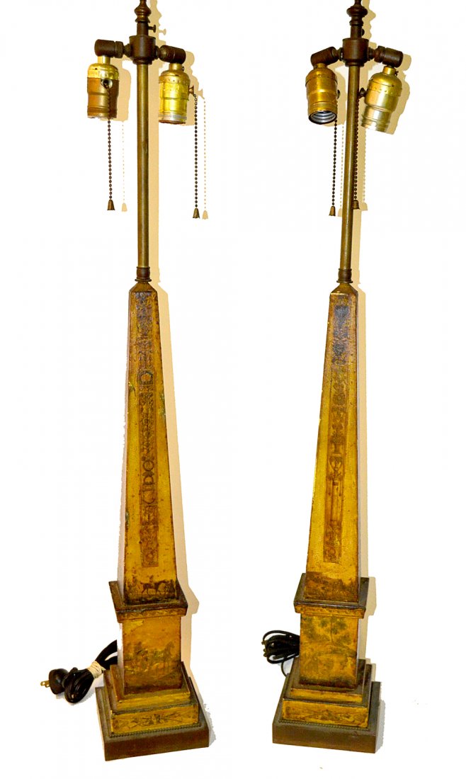 Pair of Tole Obelisk-Form Table Lamps: Yellow painted told lamps with decoupage printed elements. [5" square at base x 34 1/4" H]. Structurally sound, staining on each bear, craquelure and scratches.