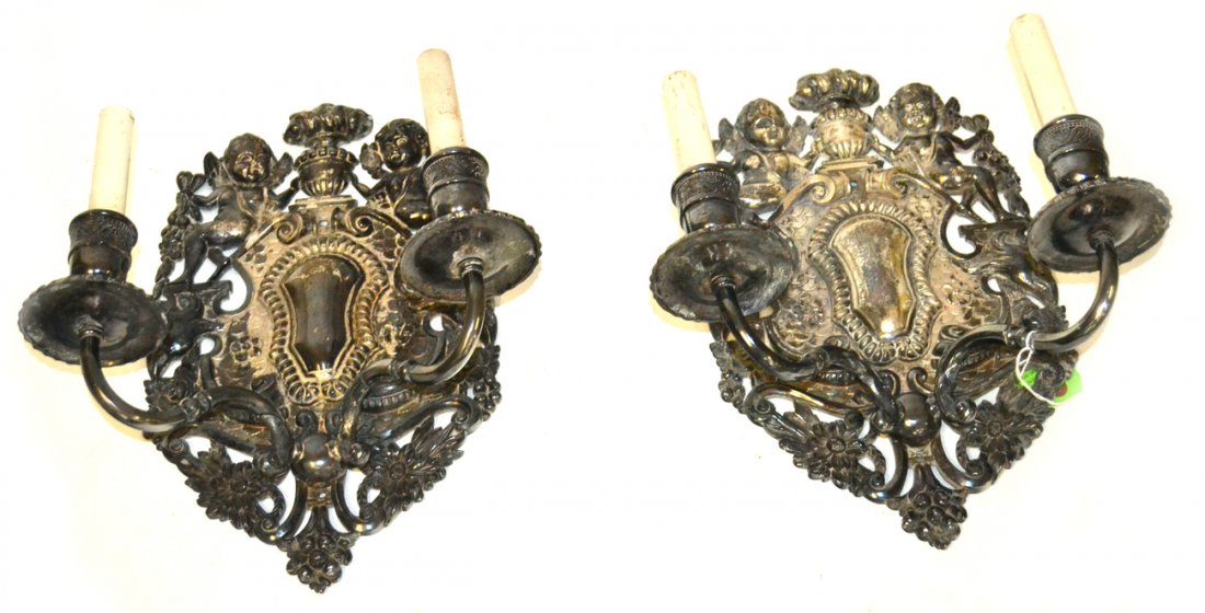 Pair of Caldwell and Co. Sconces: Pair of silver plated cherub floral and eagle carved two light sconces. Needs cleaning. [12" L x 15" H].