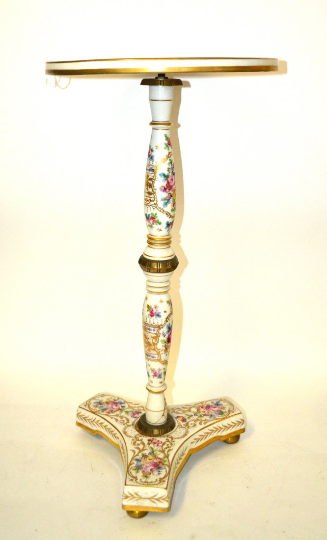 French Porcelain Table: French decorated porcelain tea table with scenic medallion and floral design. Extensive damage at column base. [15" Dia x 29 1/4" H].
