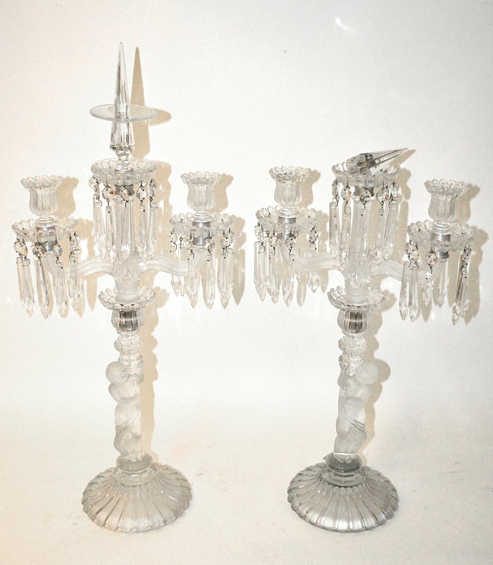 Pair of Baccarat Three Light Candelabras: Each having crystal drops and a spear finial, Baccarat. French, early 20th century. [24 1/2" H]. Good condition.