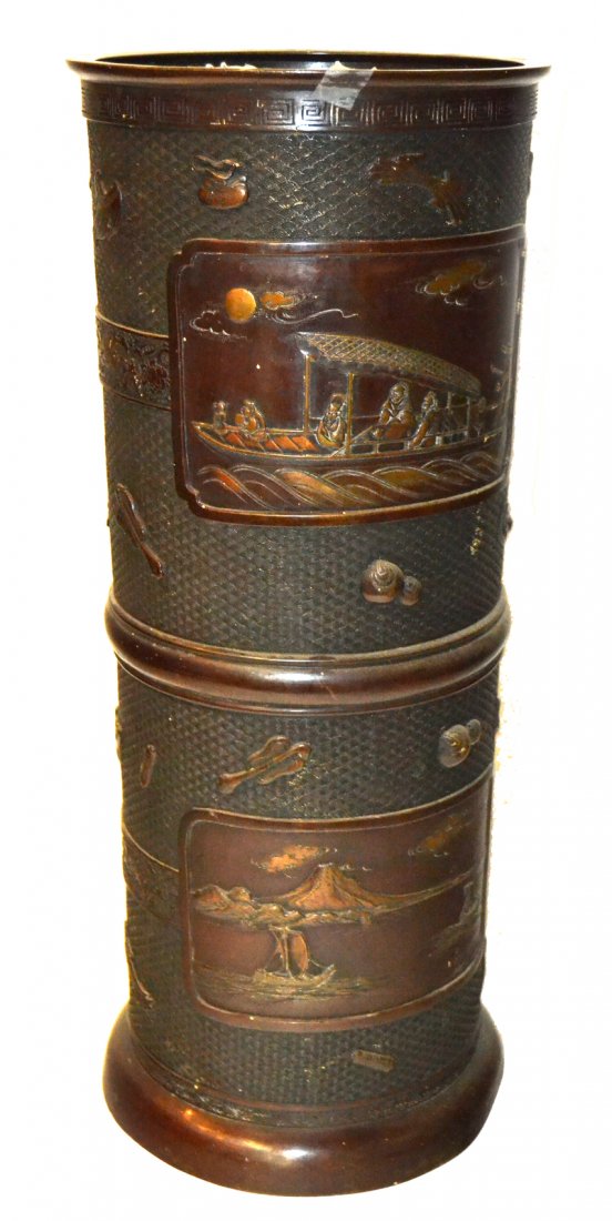 Vintage Japanese Bronze Umbrella Stand: Cylindrical bronze umbrella stand with four reserves containing low relief depictions of figures in boating scenes. [10 1/8" D x 24" H]. Missing a liner and shallow dents on the base with a reddish br