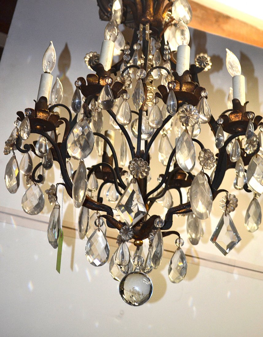 Eight-light Steel Fixture: Classical eight light fixture with a black and gilt frame and crystal prisms. [19 1/4" x 30 1/2" H]. Good condition.