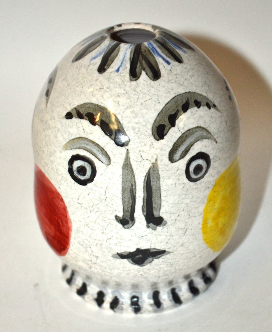 After Pablo Picasso, Ceramic Three Face Vase: Glazed ceramic ovoid vase with 5/8" opening at top center. Features three hand painted faced separated by red, yellow and blue circles. Inscribed on bottom "Picasso 2/7" at center and "Edition/Madoura