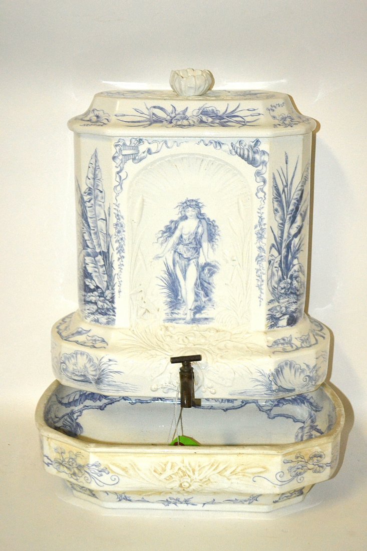 Antique French Lavabo: Features white glazed earthenware reservoir with a blue transfer figural decor and low relief ornament and bronze spigot. Marked "H.N." on back. Complete with original lid and bowl. [Reservoir 12 3/4"