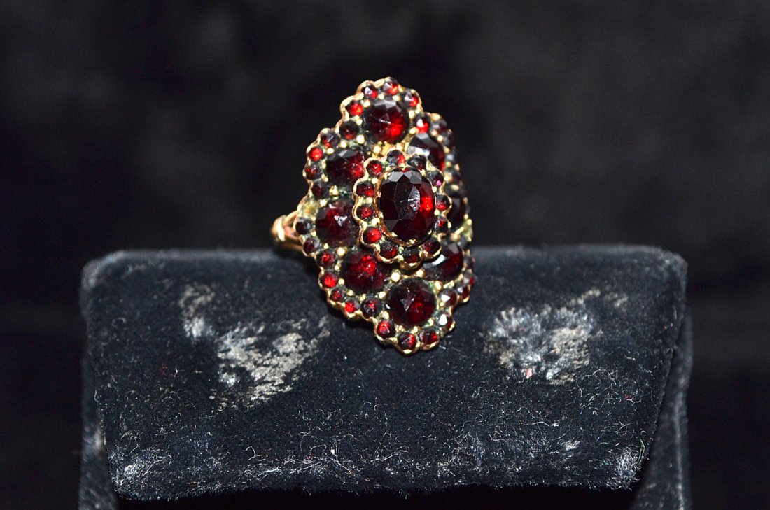 14K Yellow Gold and Bohemian Garnet Lady's Ring: 2 garnets missing. Inside of shank stamped "585". Top of ring 24 x 14mm. [2.4 dwt inclusive].