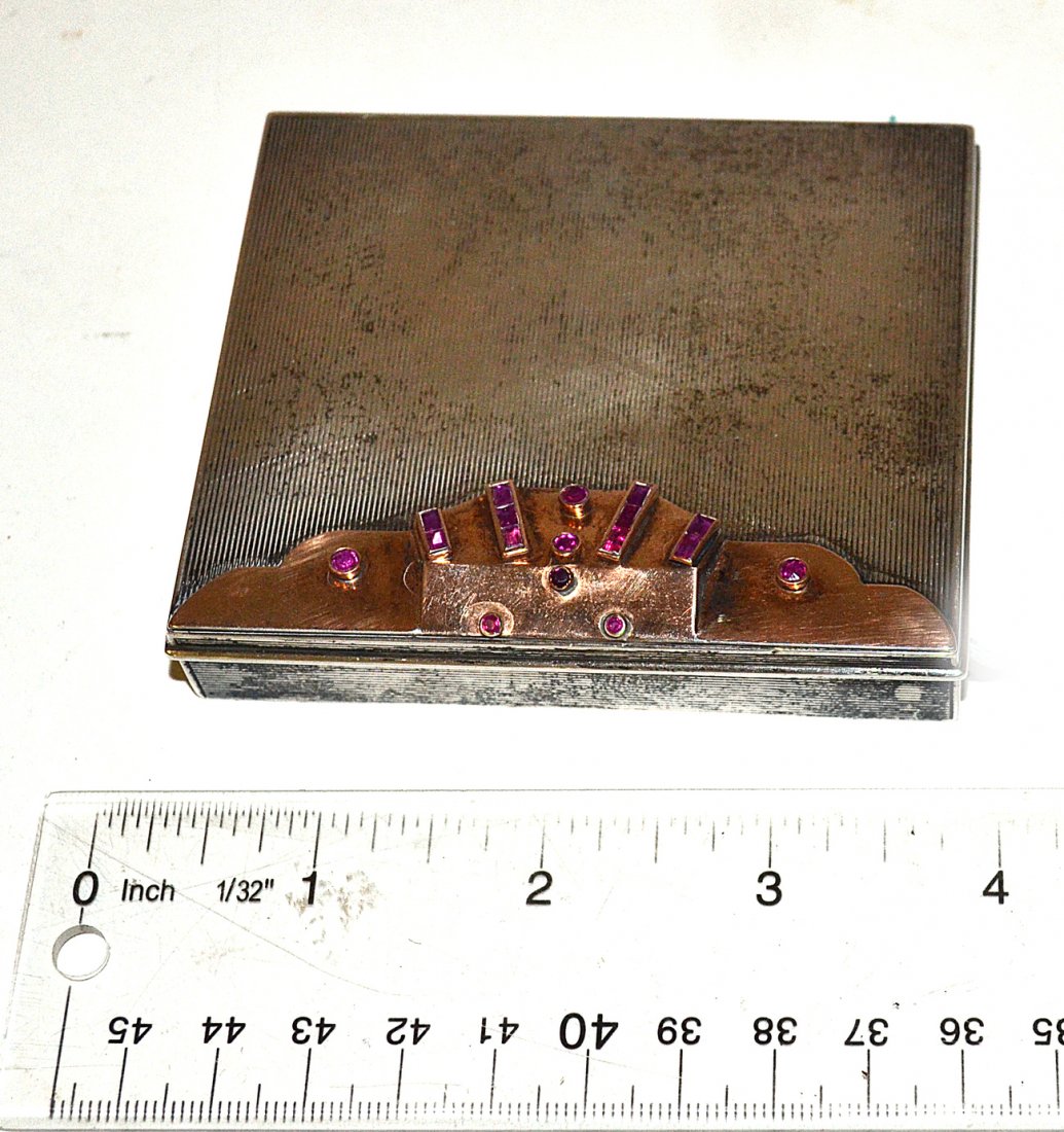 Sterling Silver and 14k Gold Art Deco Compact: Rectangular compact with a gold lid accent bearing multiple baguette and rose cut purple stones. [3 1/2" W x 3" D x 7/8" H]. 4.1 ozt. inclusive.