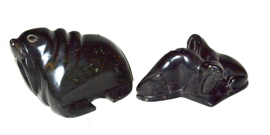 Two Inuit Soapstone Sculptures, Walruses: Comprises: 1) stylized walrus on all four legs. 4 1/2" W x 7" D x 4 1/2" H. Inscribed on bottom 'SJOC (c) 90' with Canadian inventory # "38360". Left hind foot detached. 2) Two walruses seated one in 